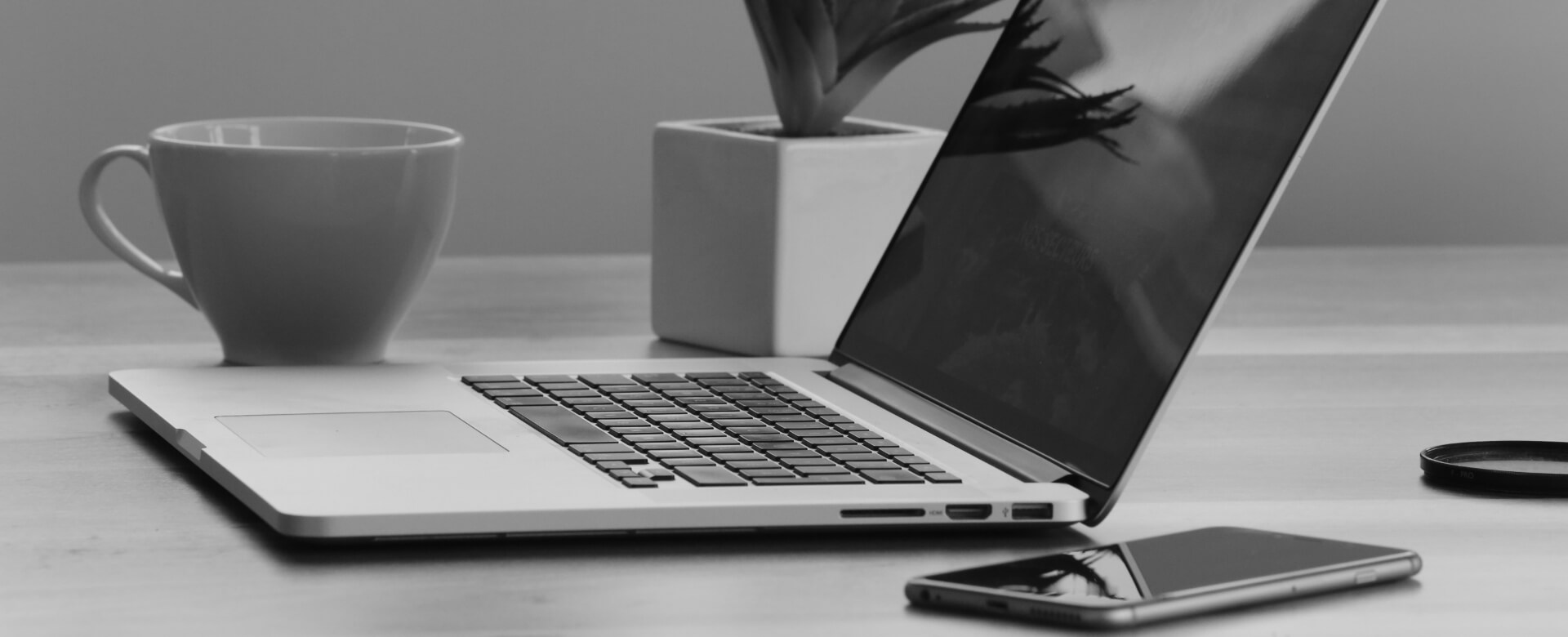 computer and coffee mug on desk